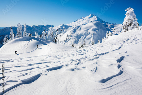 Skiers walking on snowy landscape of Artist Point in Mount Baker Snoqualmie National Forest photo