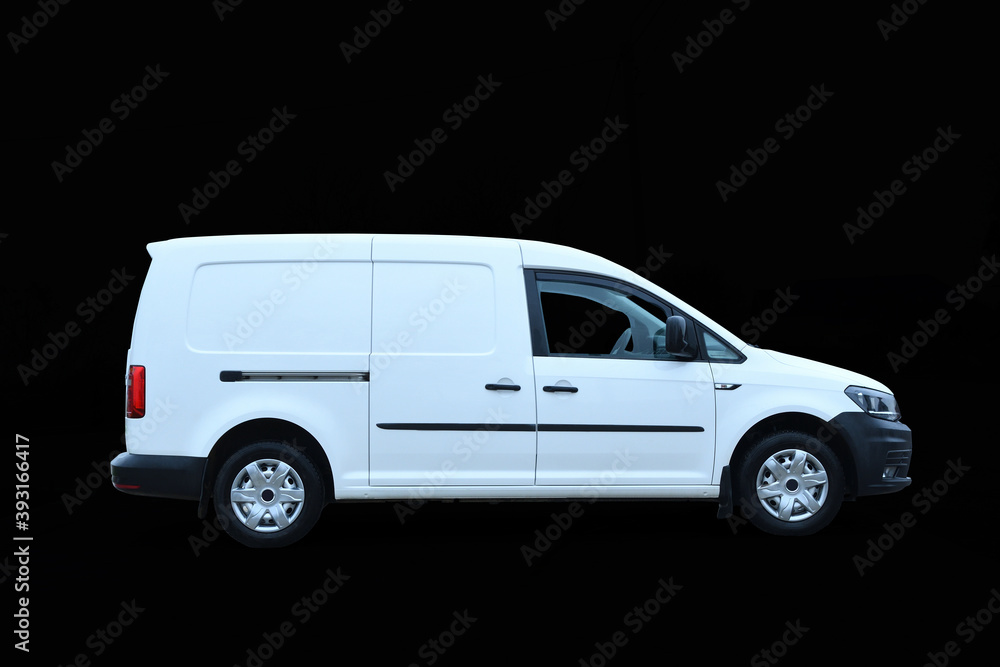 Driving white new mini van for delivery isolated on dark background cargo car