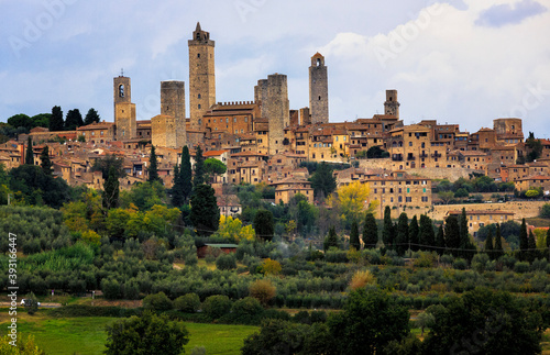 View of San Gimignano town against cloudy sky photo