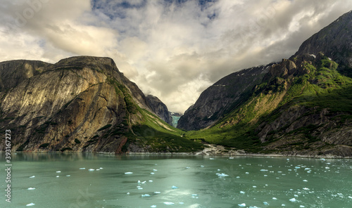 Scenic view of Tracy Arm fjord and mountain against cloudy sky photo