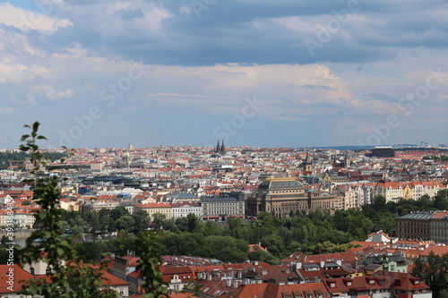 Panorama of beautiful Prague and the Vltava river embankment against the background of clouds from Hradcany on a hot summer day