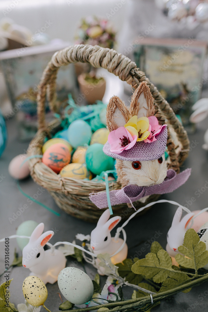 Easter basket with bunny decoration filled with dyed easter eggs