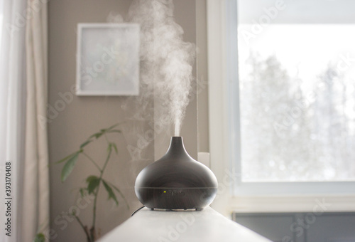 Essential oils diffusing at home in the morning light photo