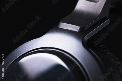 Elegant black headphones on black background with nice reflections