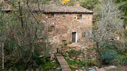 Old and restored water mill in the deep of the forest.