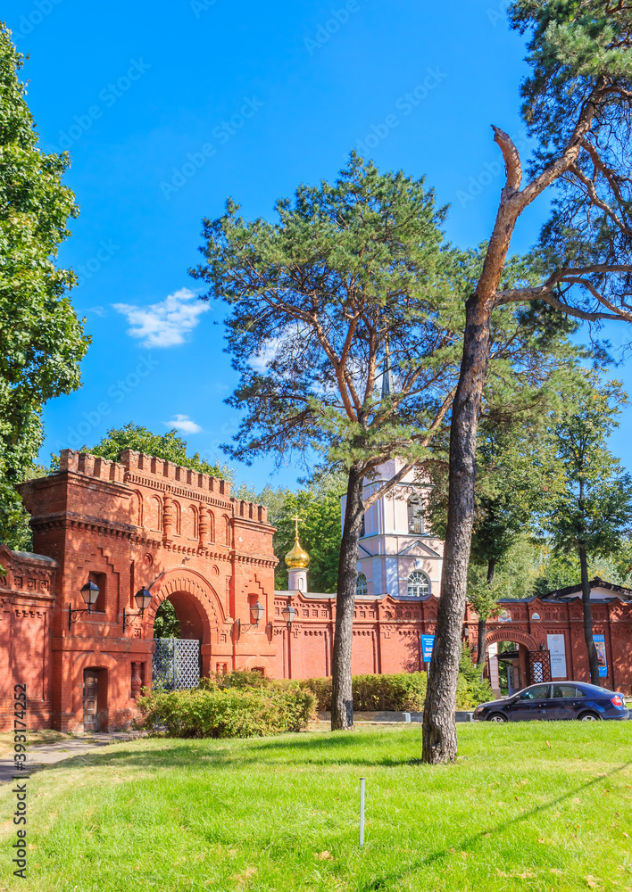 Huge old brick gates of the Pokrovskoe-Streshnevo Estate on a Sunny summer day. Moscow. Russia