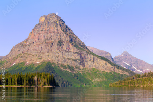 Sinopah Mountain with Full Moon from and blue sky, Two Medicine Lake photo
