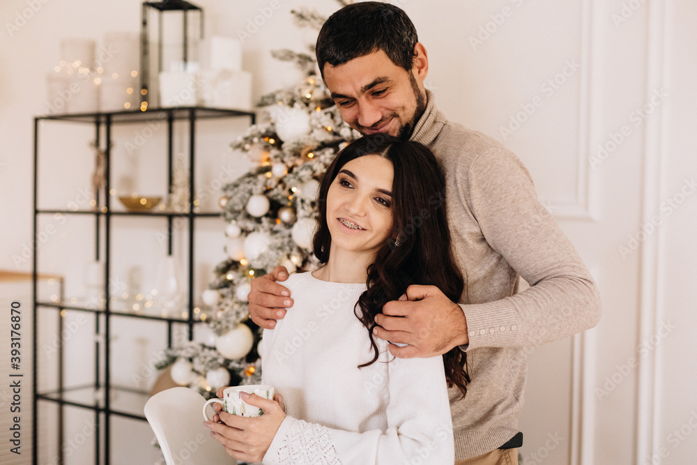 couple in love under the tree for christmas couple in love under the tree for christmas