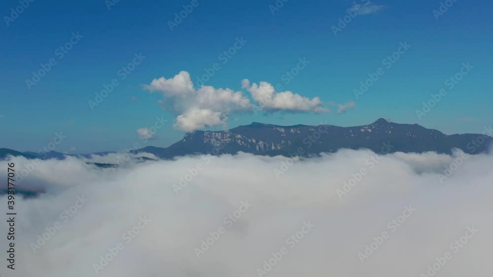 Morning fog above the lake, drone flying above fog in a summer mountain landscape Morning fog above the lake, drone flying above fog in a summer mountain landscape