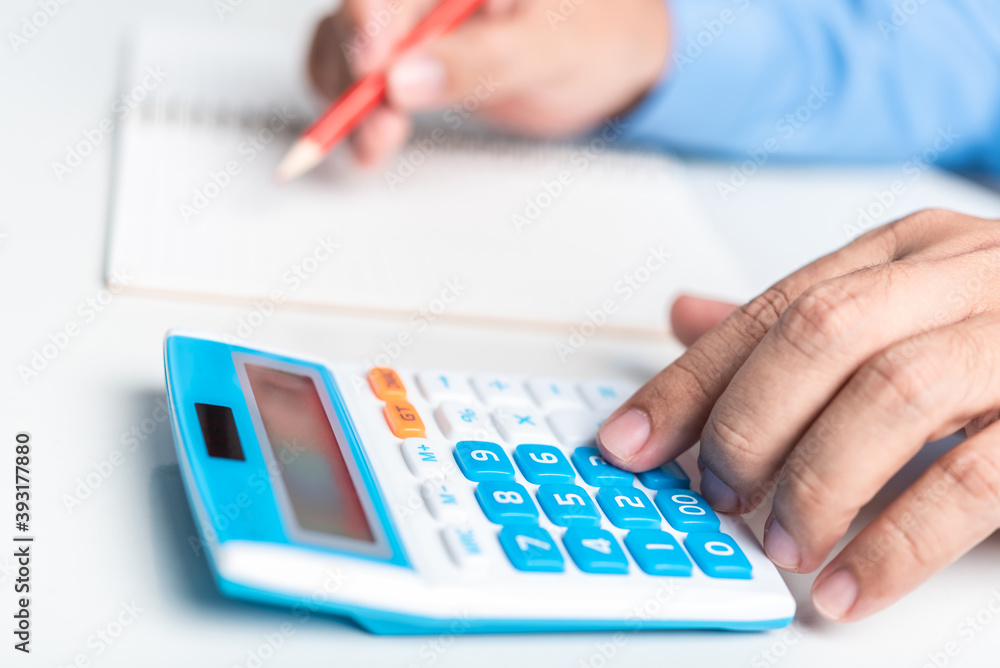 man hand use calculator with financial spreadsheet data man hand use calculator with financial spreadsheet data