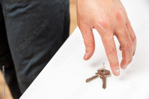 Unrecognizable person holding up a keys at home