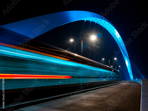 Lighted tram bridge at night. Strasbourg. Moving tram. Passerell photo