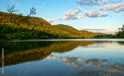 Fototapeta Naklejka Na Ścianę i Meble -  forest hills reflecting in the water of a beautiful lake