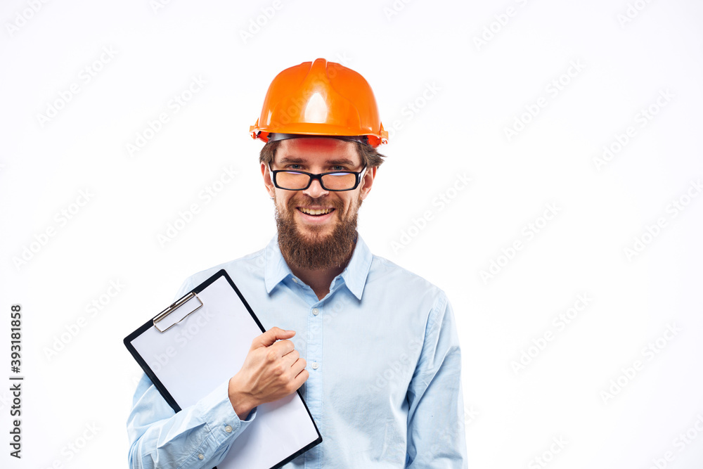 A man in orange paint in glasses documents a manual industry A man in orange paint in glasses documents a manual industry
