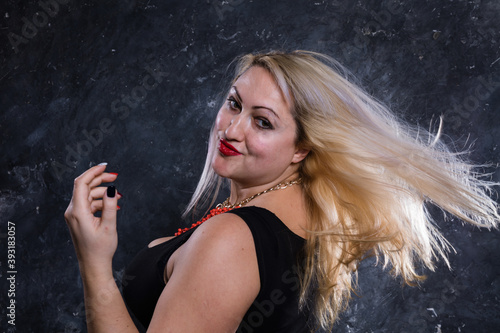 Attractive plump woman with flowing hair studio portrait close up view. photo