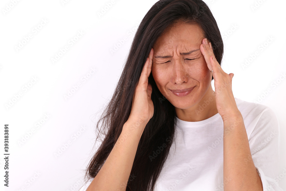 Woman suffering from headache, covering ears, annoyed by loud noise Woman suffering from headache, covering ears, annoyed by loud noise