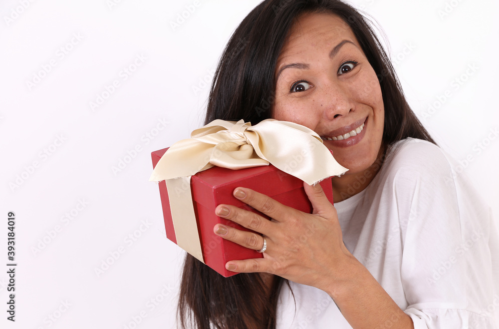 Smiling Asian Woman holding present box Portrait. Imperfect and Authentic beauty. Smiling Asian Woman holding present box Portrait. Imperfect and Authentic beauty.