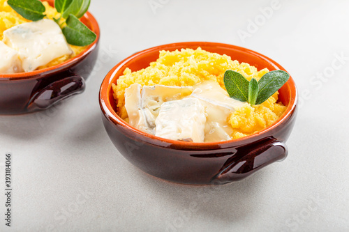 Dish of polenta with melted gorgonzola cheese