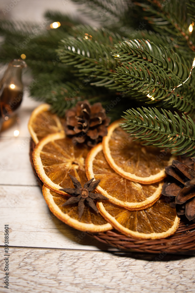 Christmas tea with dried orange in a basket with garland and fir branches and cones Christmas tea with dried orange in a basket with garland and fir branches and cones