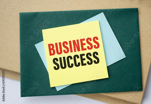 Business Success written on color sticky notes over white background.
