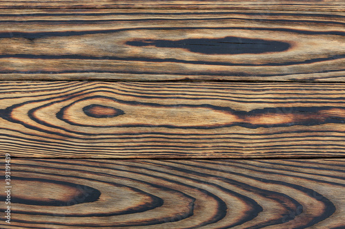 A background of burnt pine planks with scraped softwood and exposed with oak stain. Copy space.