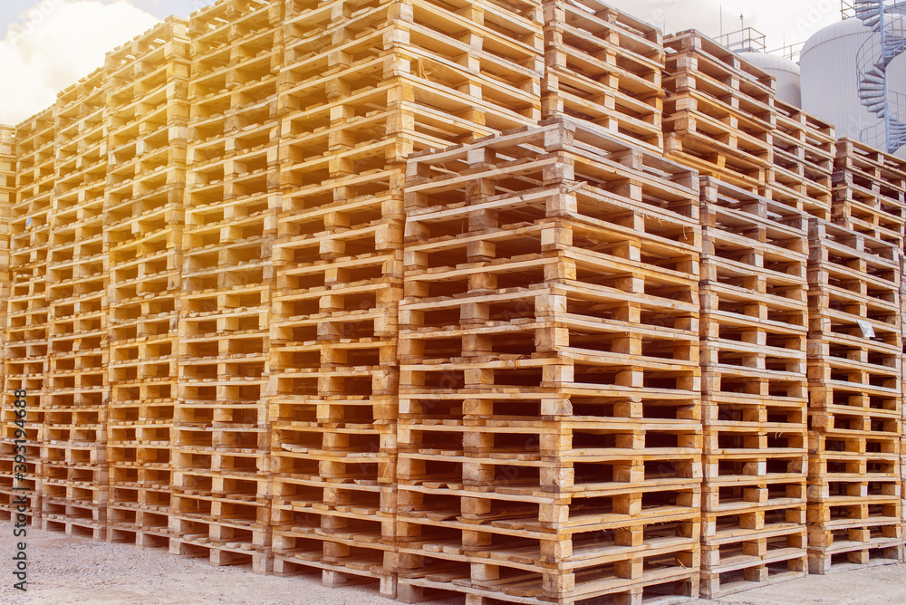 Wooden Euro pallets stacked in big industrial storehouse Wooden Euro pallets stacked in big industrial storehouse