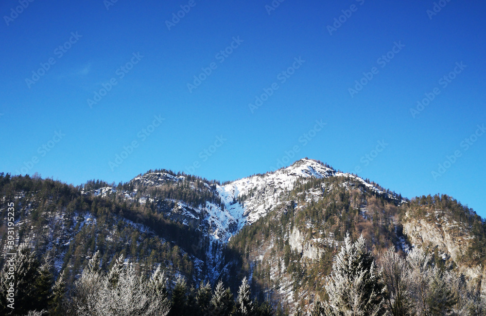 snow covered mountains and blue sky in winter