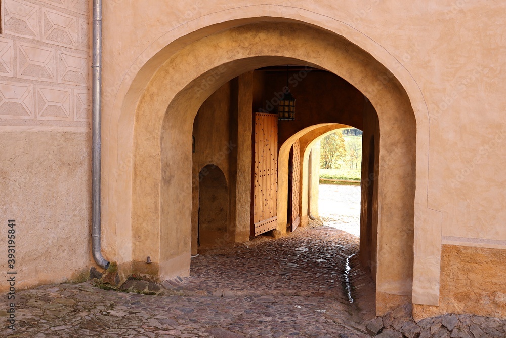 Naklejka premium Large arch in the thick wall for access to the courtyard