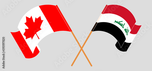 Crossed and waving flags of Canada and Iraq