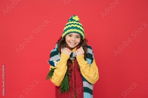kid with happy face wearing warm winter clothing and get ready for holidays, knitted accessory