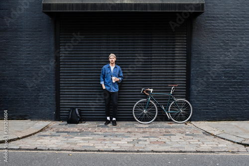 Photography Professional Freelancer Young Man Standing With His Bike And Holding Coffee Outside
