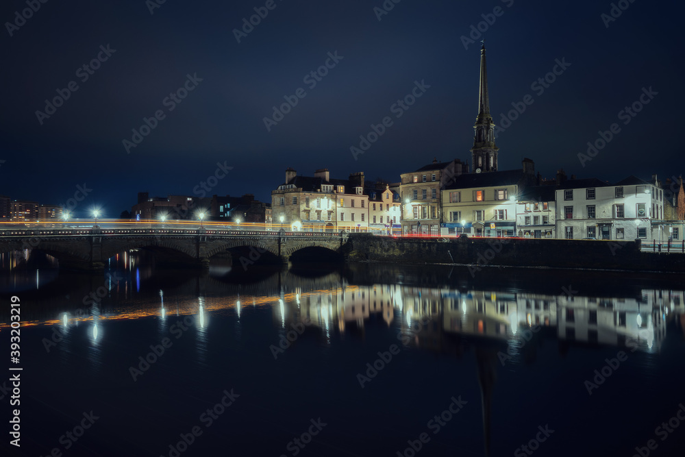 Night view of bridge over the River Ayr and embankment at the Ayr city. Street lamps light. Ayr, Scotland, United Kingdom