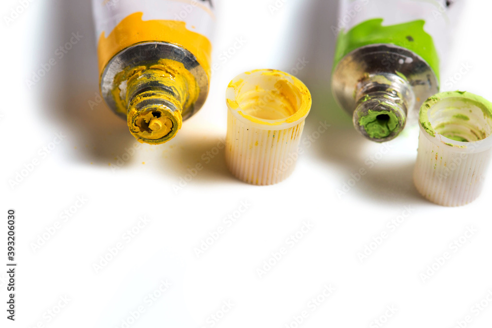 Dried green and yellow watercolor paint in a tube isolated on white Dried green and yellow watercolor paint in a tube isolated on white
