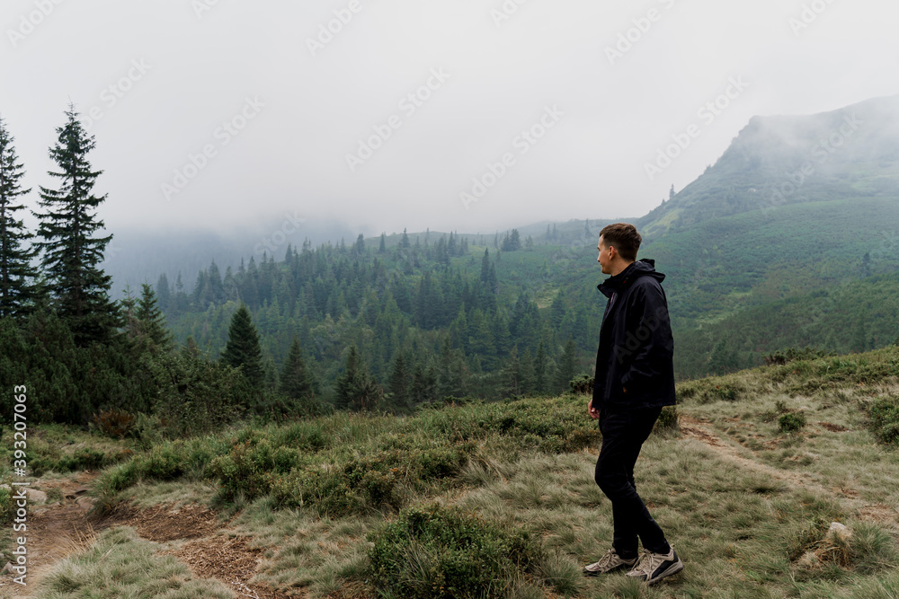 Tourism travelling in Ukraine. Men enjoy the mountain hills view. Feeling freedom in Karpathian mountains.