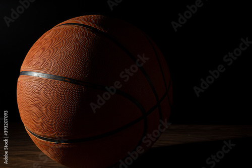 Basketball ball in a dark background. © Stefano
