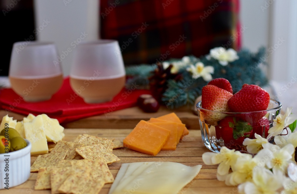 Festive winter Christmas holiday charcuterie board with white wine and seasonal decor ready for sharing