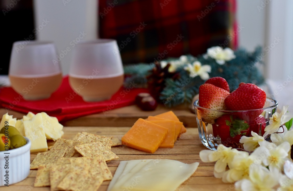 Festive winter Christmas holiday charcuterie board with white wine and seasonal decor ready for sharing Festive winter Christmas holiday charcuterie board with white wine and seasonal decor ready for sharing