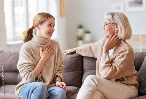 Cuadro en lienzo Mother and daughter speaking on couch.