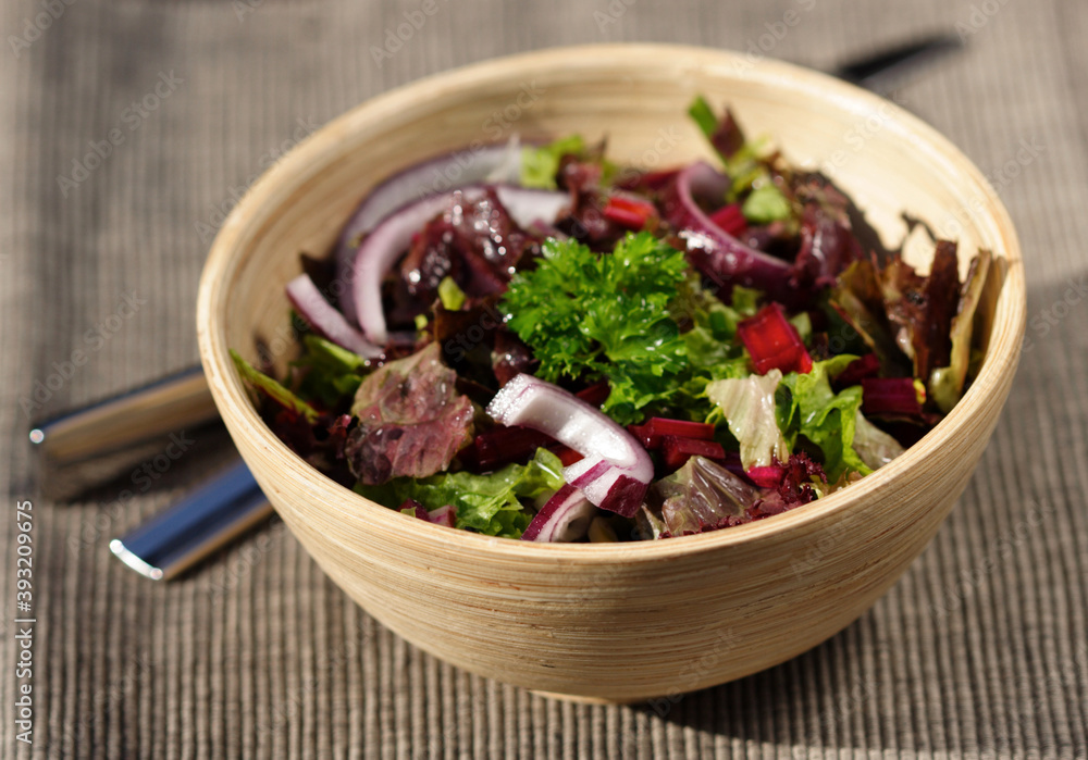 Close-up of spring salad in wooden bowl Close-up of spring salad in wooden bowl