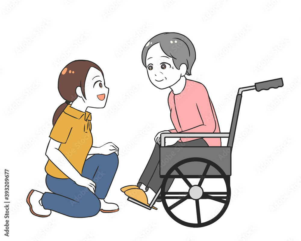 車椅子の高齢女性と会話　女性介護士