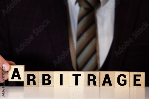 Fotografie ARBITRAGE word made with building blocks