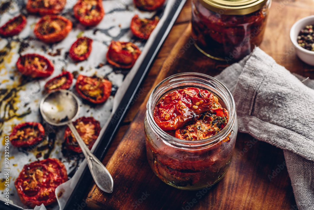 Preserving of Sun Dried Tomatoes with Herbs in a Jar - obrazy, fototapety, plakaty 