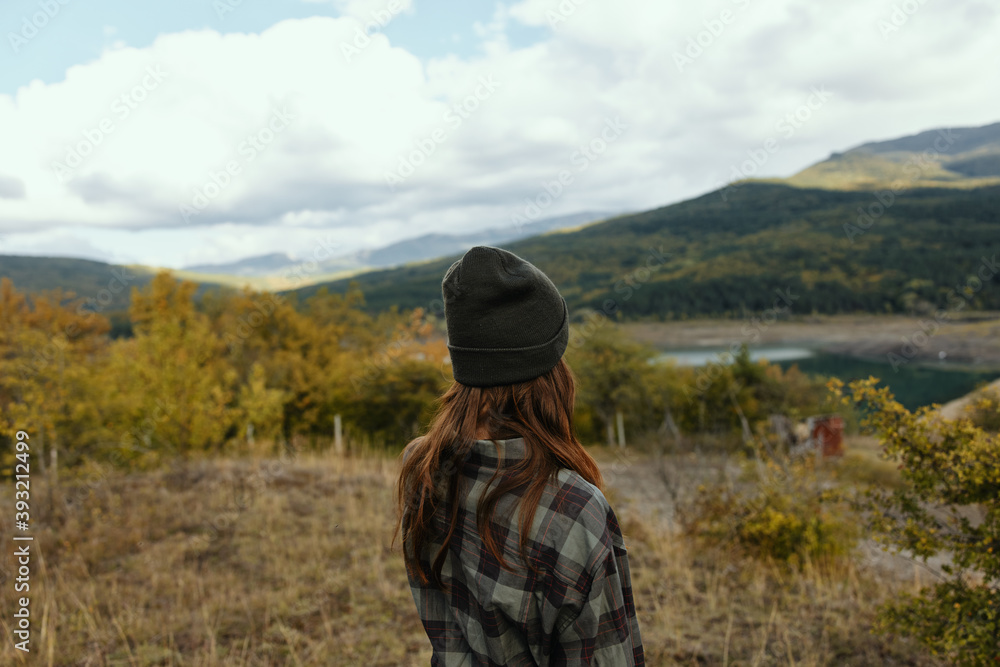 Woman tourist taxing in mountains and dry grass nature fresh air model Woman tourist taxing in mountains and dry grass nature fresh air model