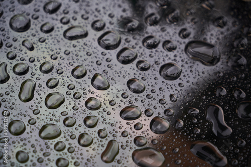 Rain drops on glass background. Raindrops on glass with reflection