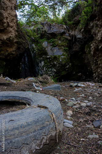 waterfall contaminated with car tires
