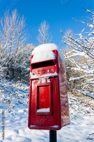 Traditional red postbox in the snow