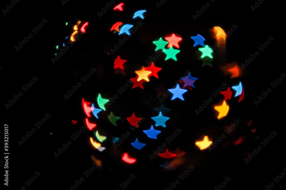 Abstract of colorful background. star shaped bokeh light. shimmering blur spot lights on multicolored holiday background