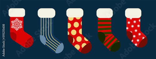 Christmas and New year holiday traditional colorful socks with holiday patterns. Deer and Santas helpers elves on present warm winter stockings and candy strips flat vector isolated icon set.