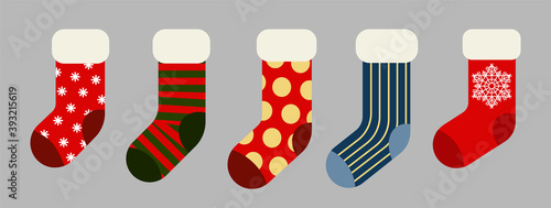 Christmas and New year holiday traditional colorful socks with holiday patterns. Deer and Santas helpers elves on present warm winter stockings and candy strips flat vector isolated icon set.