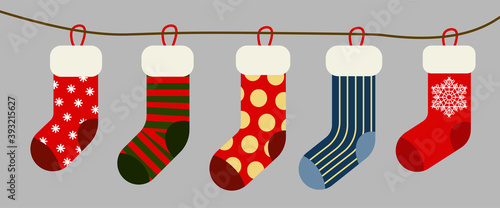 Christmas and New year holiday traditional colorful socks with holiday patterns. Deer and Santas helpers elves on present warm winter stockings and candy strips flat vector isolated icon set.